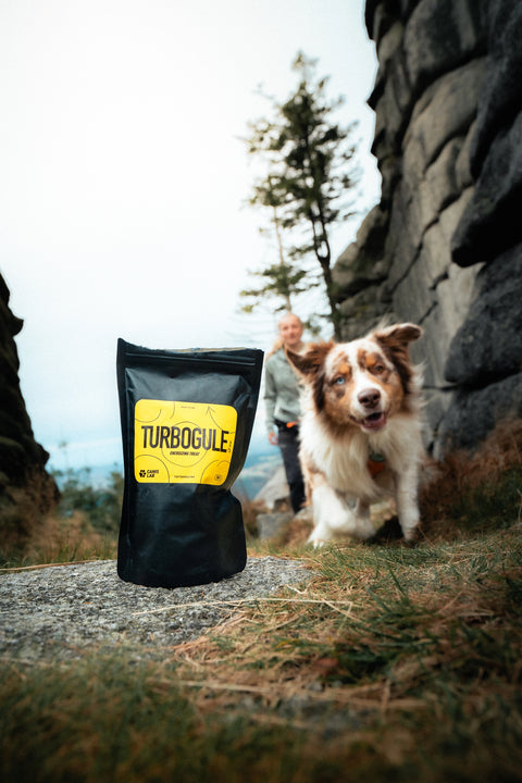 Turbogule dog treat bag, with blurred Australian Shepherd dog running behind it